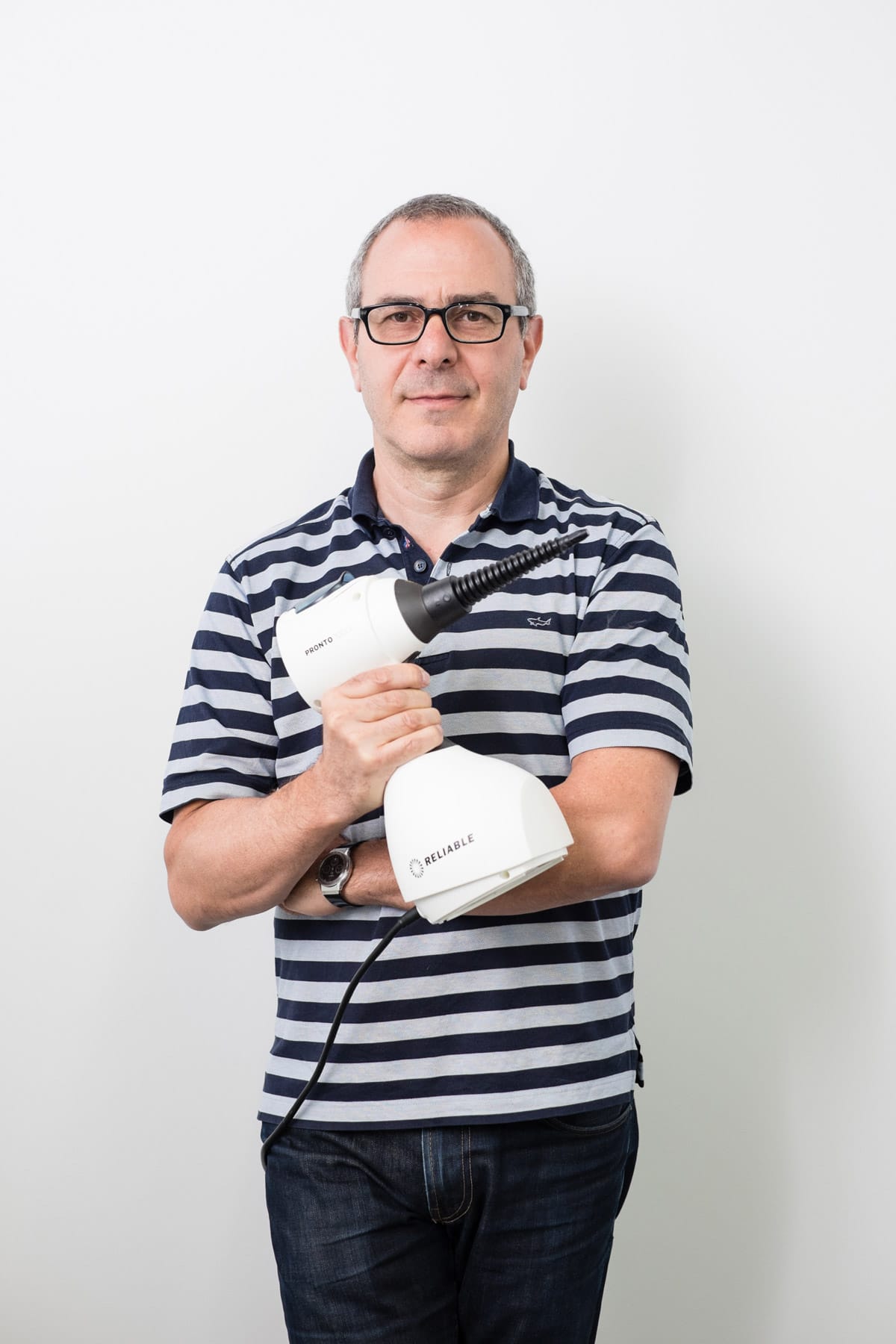Corporate and professional headshot of man in a striped shirt