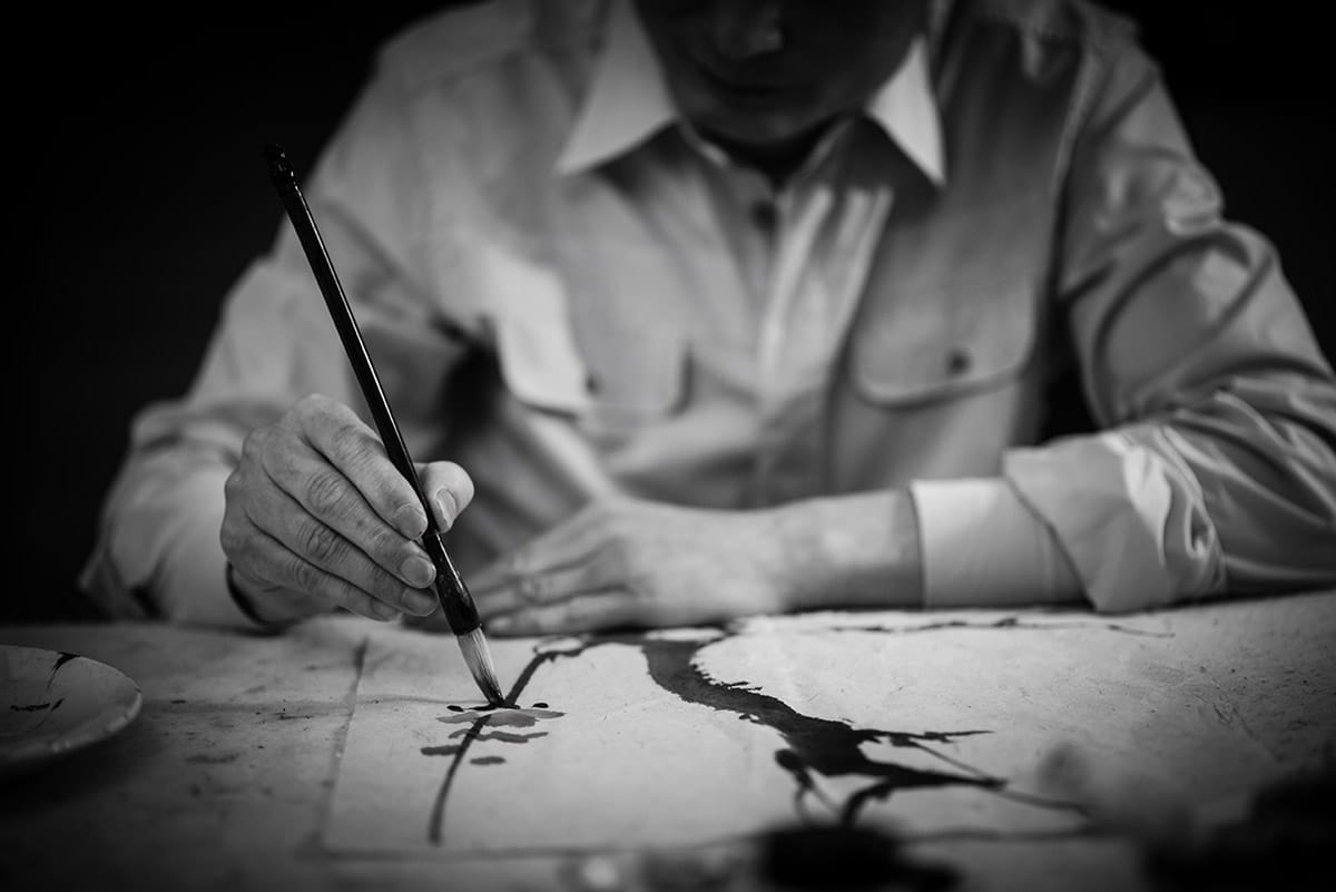 personal branding black and white photo of a man painting