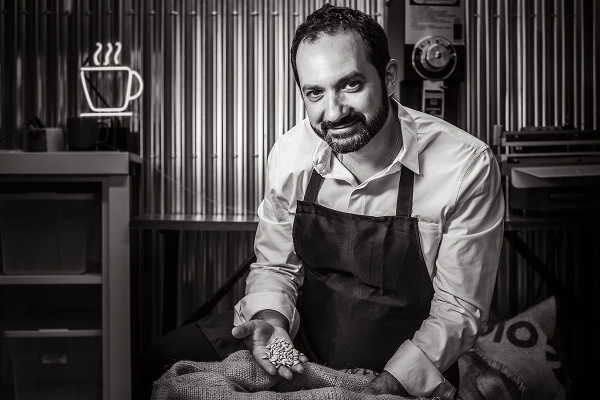 Personal branding portrait of a man holding some coffee beans