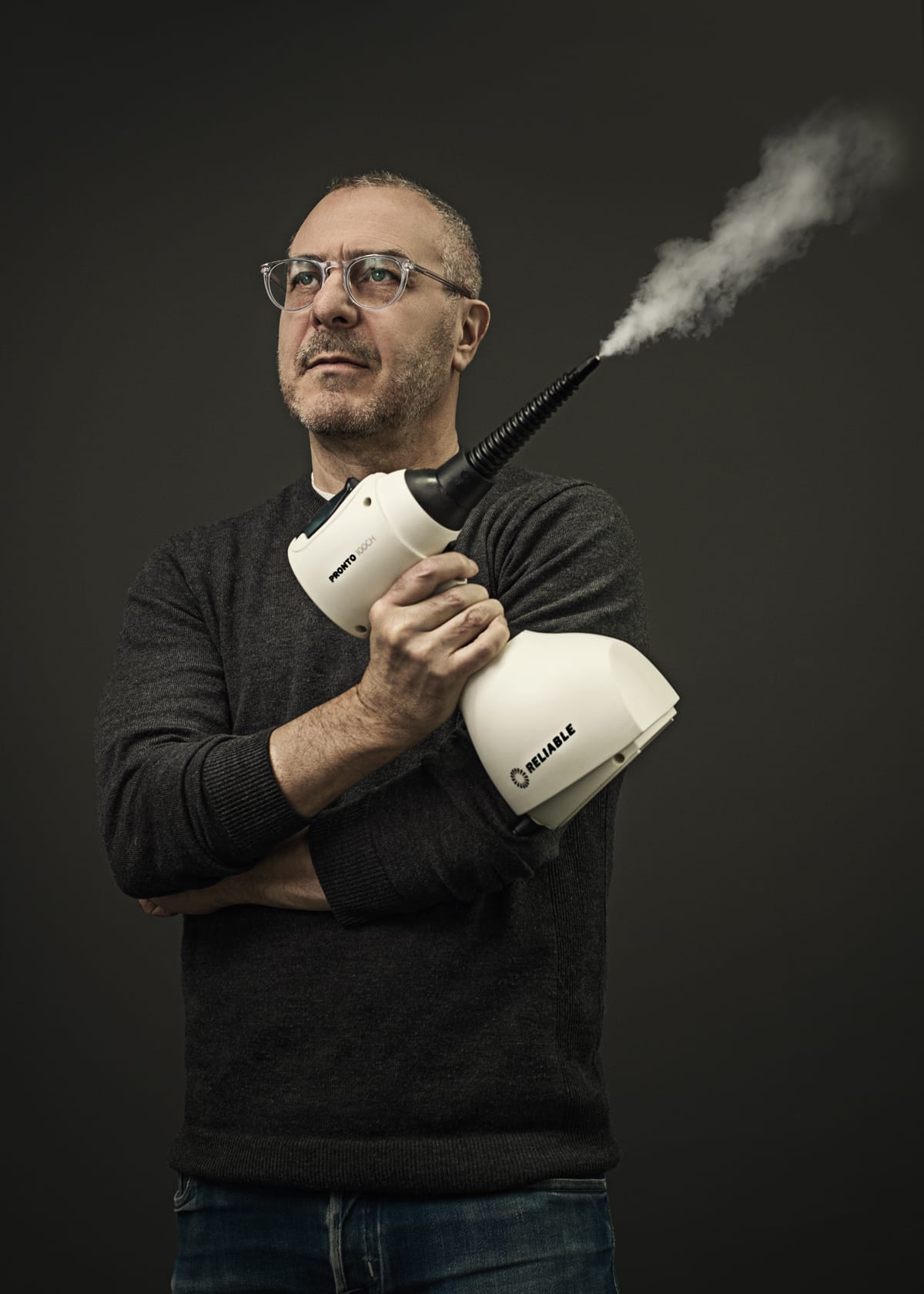 Corporate and professional portrait of a man with a handheld steamer