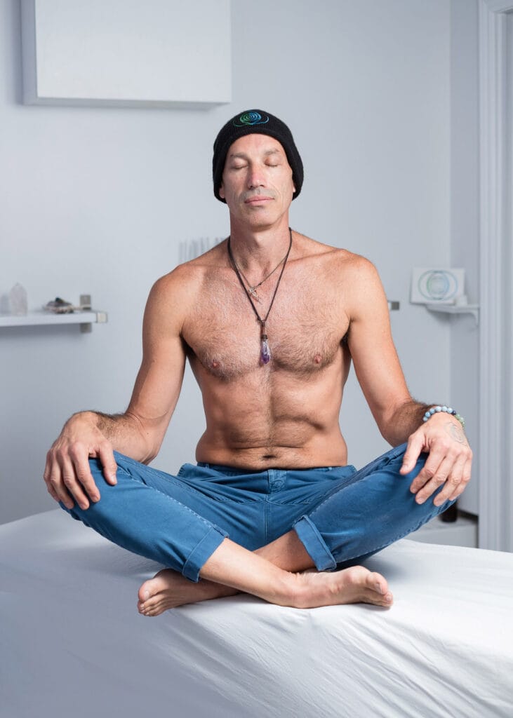 Branding portrait of a chiropractor sitting cross-legged and with closed eyes