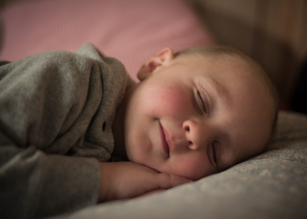 Family portrait photograph of a baby sleeping
