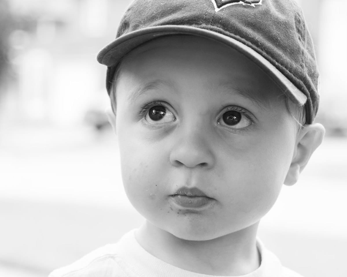 Child portrait photograph of a kid wearing a hat