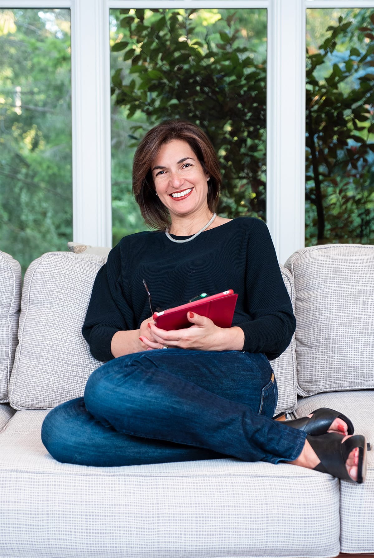 personal branding photo of a real estate agent sitting on a sofa