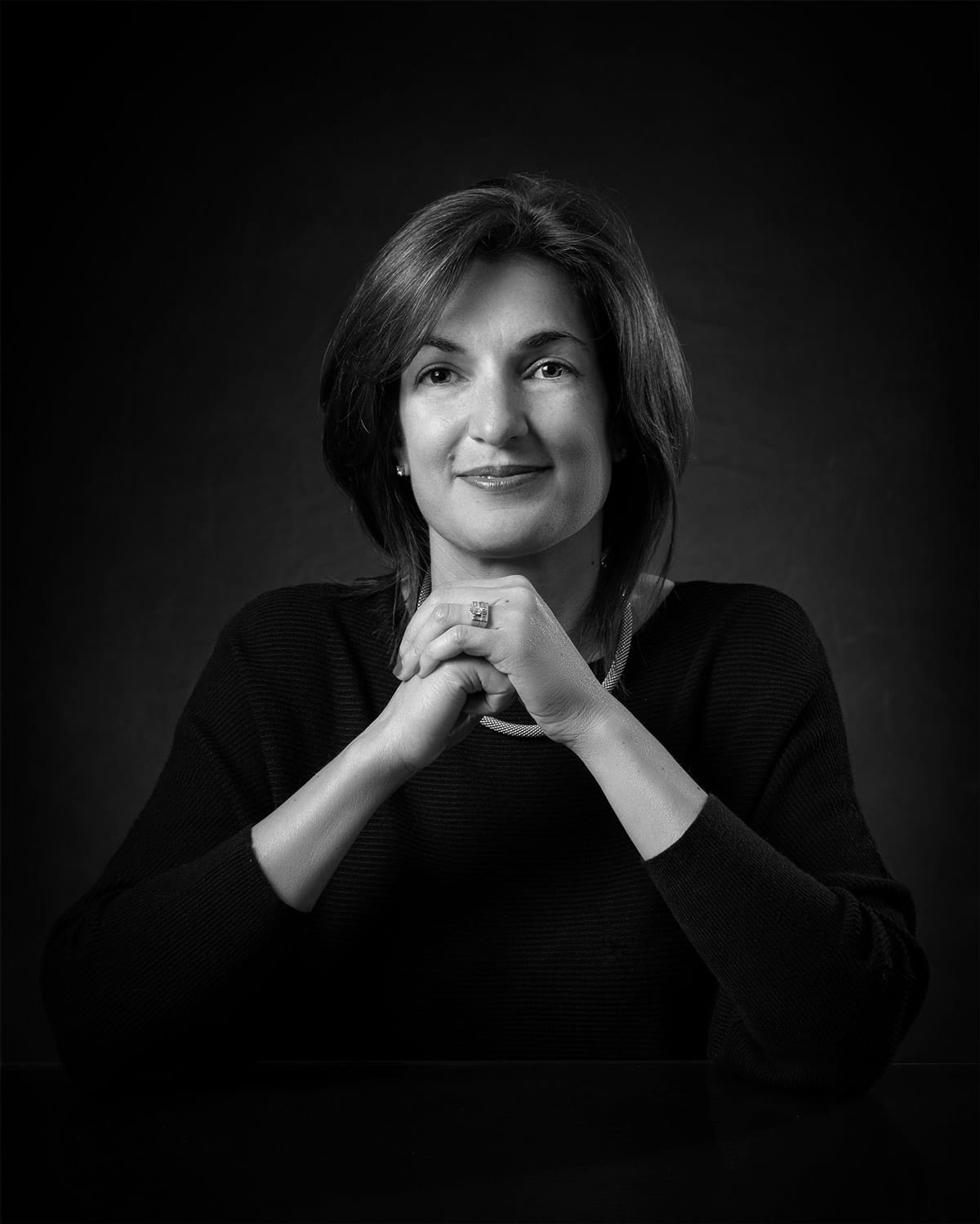 personal branding photo of a real estate agent clasping her hands in front of her
